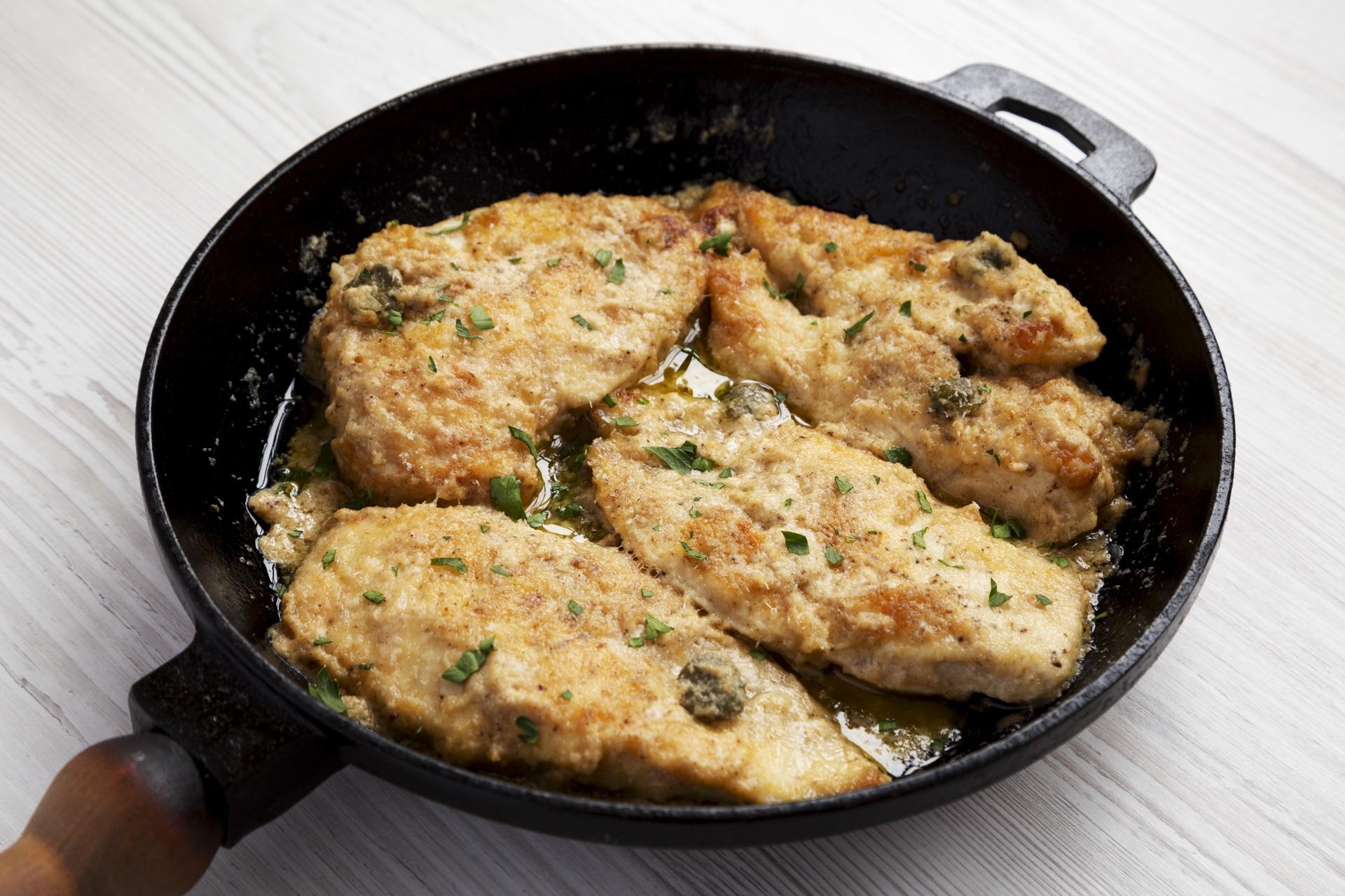 Chicken Piccata with lemon-caper butter sauce on a white plate